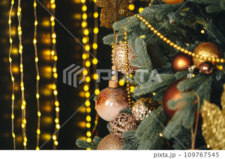 Beautiful Christmas tree with golden balls decor close up 109767545