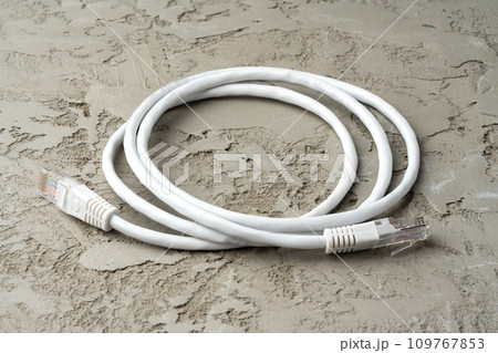 White network cable patch-cord on gray textured background 109767853