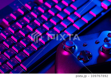 Computer keyboard and joystick on black background close up 109767892