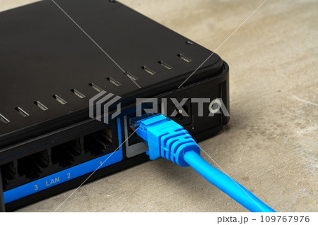 Modern router with cables plugged in close up Modern router with cables plugged in close up 109767976