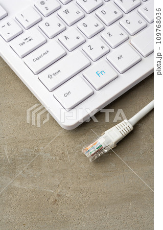 Computer keyboard with network cable close up Computer keyboard with network cable close up 109768036