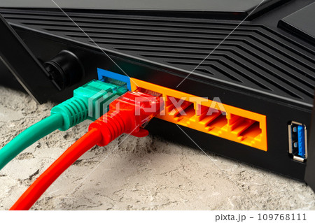 Colored network cable patch-cord on gray textured background 109768111
