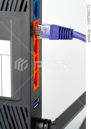 Modern router with cables plugged in close up 109768171