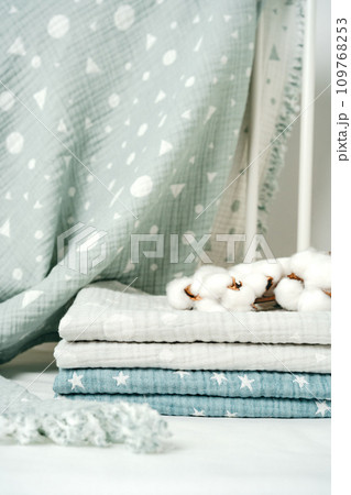 Stack of cotton blankets for a newborn in a cradle 109768253