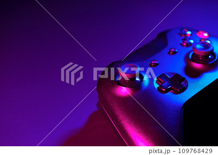 Gaming joystick on black background in neon light Gaming joystick on black background in neon light 109768429