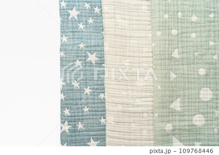 Three folded cotton blankets on white background Three folded cotton blankets on white background 109768446