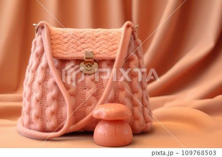 Handbag in a soft peach color with knitted elements 109768503