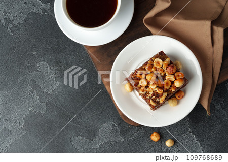 Brownie cake with chocolate and hazelnuts on plate 109768689