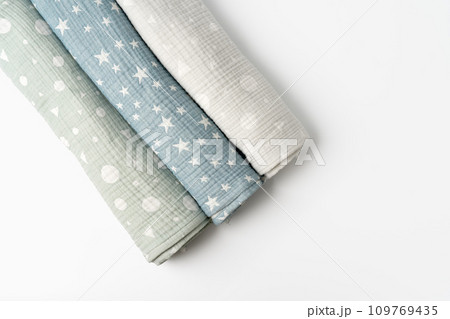 Three rolled muslin blankets on white backgorund 109769435