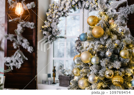 Christmas tree with toys baubles close-up on window background Christmas tree with toys baubles close-up on window background 109769454