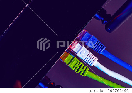 Cables plugged in a Wi-Fi router on dark background 109769496