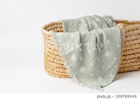 Baby cradle with muslin blanket and wooden toys in a baby room Baby cradle with muslin blanket and wooden toys in a baby room 109769549