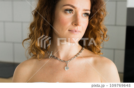 Close-up Female with silver pendant heart close-up. Image for e-commerce, online selling, social media, jewelry sale. Handmade jewelry Close-up Female with silver pendant heart close-up. Image for e-commerce, online selling, social media, jewelry sale. Handmade jewelry 109769648