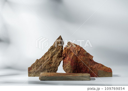 Piece of granite stone on white background with shadows 109769854