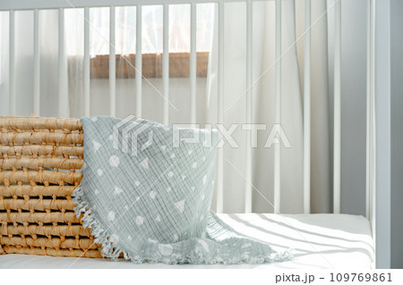Nursery interior and bedding for kids with wicker bassinet 109769861