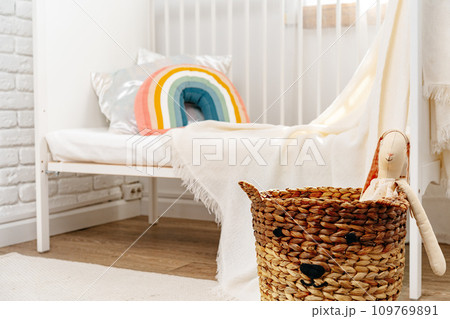 Kid's room interior with comfortable bed and rainbow pillow 109769891