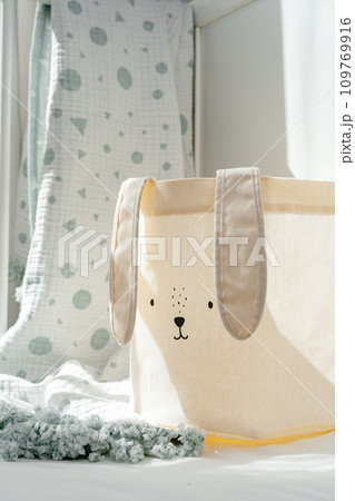 Rabbit basket for toys and blanket in baby bed Rabbit basket for toys and blanket in baby bed 109769916
