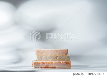 Piece of granite stone on white background with shadows Piece of granite stone on white background with shadows 109770153