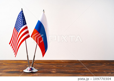 Small flags of Russia and USA on flagpoles close up 109770304