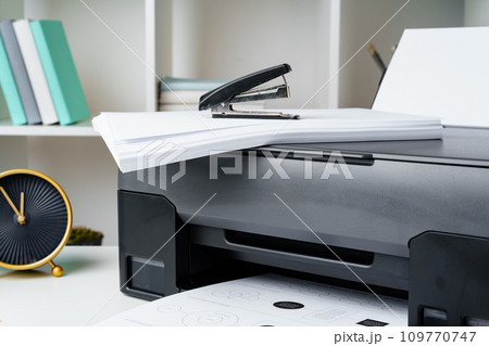Workplace with modern printer and clock in the office 109770747