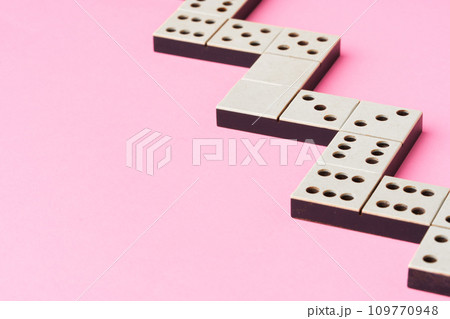 Domino tiles on pink background studio shot Domino tiles on pink background studio shot 109770948