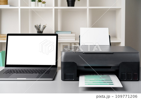 New modern printer and laptop in the office on table New modern printer and laptop in the office on table 109771206