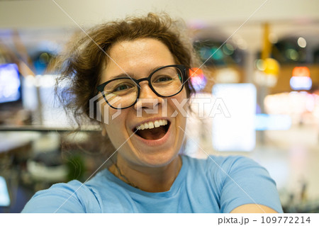 Video call portrait of excited cheerful smiling woman in spectacles taking selfie photo. Selfie and blogger concept 109772214