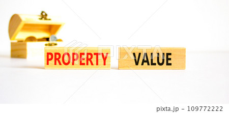 Property value symbol. Concept words Property value on beautiful wooden blocks. Beautiful white table white background. Wooden beautiful chest with coins. Business property value concept. Copy space. Property value symbol. Concept words Property value on beautiful wooden blocks. Beautiful white table white background. Wooden beautiful chest with coins. Business property value concept. Copy space. 109772222