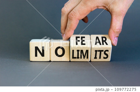 No fear and limits symbol. Concept words No fear No limits on wooden block. Beautiful grey table grey background. Businessman hand. Business motivational no fear and limits concept. Copy space. 109772275