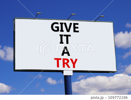 Give it a try symbol. Concept word Give it a try on beautiful big white billboard. Beautiful blue sky cloud background. Business give it a try concept. Copy space. 109772286