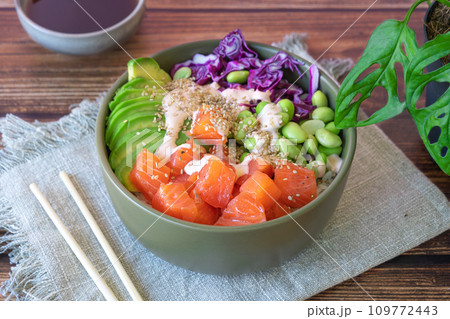 poke bowl with salmon on the wooden table poke bowl with salmon on the wooden table 109772443
