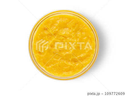 Fresh mashed mango in bowl on white background.Top view. Fresh mashed mango in bowl on white background.Top view. 109772609