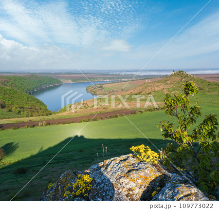 Amazing spring view on the Dnister River Canyon with picturesque rocks, fields, flowers. This place named Shyshkovi Gorby, Nahoriany, Chernivtsi region, Ukraine. Amazing spring view on the Dnister River Canyon with picturesque rocks, fields, flowers. This place named Shyshkovi Gorby, Nahoriany, Chernivtsi region, Ukraine. 109773022
