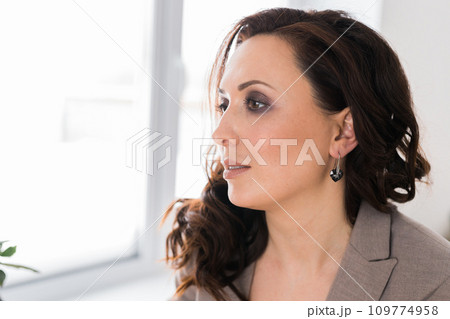 Detail of young woman wearing beautiful luxury earring close-up. Handmade jewellery and accessories copy space 109774958