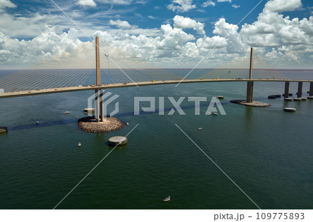 Sunshine Skyway Bridge over Tampa Bay in Florida with moving traffic. Concept of transportation infrastructure Sunshine Skyway Bridge over Tampa Bay in Florida with moving traffic. Concept of transportation infrastructure 109775893