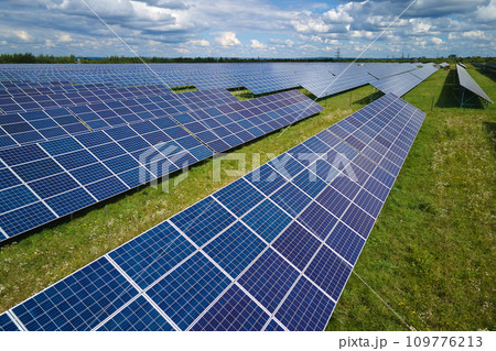 Aerial view of big sustainable electric power plant with many rows of solar photovoltaic panels for producing clean electrical energy. Renewable electricity with zero emission concept 109776213