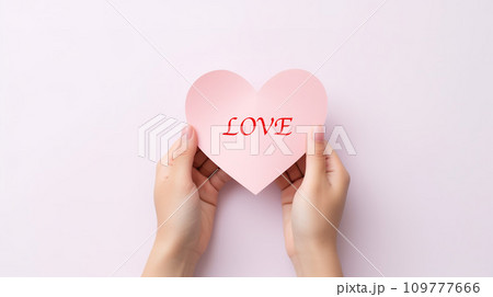 Hands holding heart-shaped pink paper on white background. Generative AI. 109777666