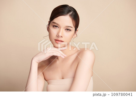 Beautiful young asian woman with clean fresh skin on beige background, Face care, Facial treatment, Cosmetology, beauty and spa, Asian women portrait. 109780041