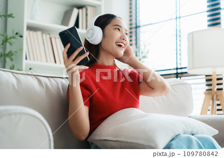 Young Asian woman relaxing on sofa at home 109780842