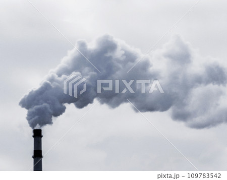 Thick dark smoke from the chimney against the sky. Thick dark smoke from the chimney against the sky. 109783542