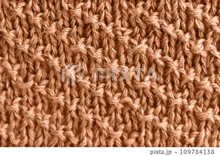 Peach wool knit with diagonal stripes. Color of the year 2024 Peach wool knit with diagonal stripes. Color of the year 2024 109784138