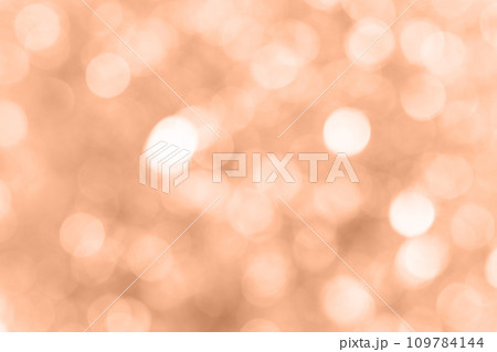 Blurred background with holiday lights. Showcasing the color of 2024 peach Blurred background with holiday lights. Showcasing the color of 2024 peach 109784144