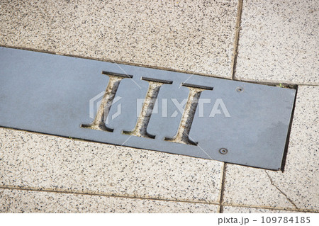 Roman numerical number three made of stone tiles on street Roman numerical number three made of stone tiles on street 109784185
