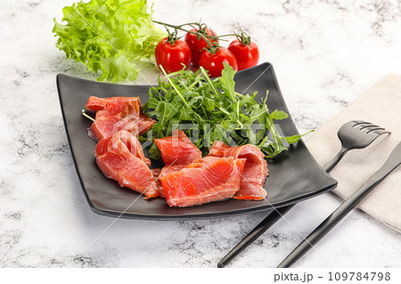 Sliced salmon with fresh arugula Sliced salmon with fresh arugula 109784798