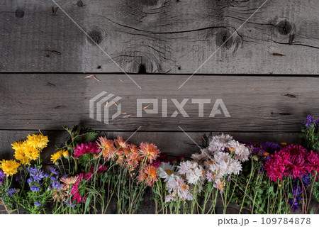 Wild Colorful Rustic Flowers Bouquet from Daisy, Chrysanthemum and Others on Wooden Rustic Table. Mothers Day, Summer and Spring Holidays Wallpaper. Wild Colorful Rustic Flowers Bouquet from Daisy, Chrysanthemum and Others on Wooden Rustic Table. Mothers Day, Summer and Spring Holidays Wallpaper. 109784878