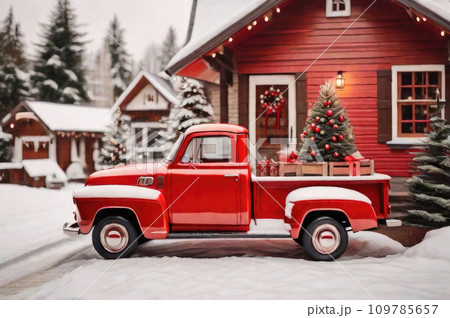 A red retro Christmas truck with gifts and a Christmas tree in the back near a decorated house in winter with snow. A holiday card for Christmas and New Year. A red retro Christmas truck with gifts and a Christmas tree in the back near a decorated house in winter with snow. A holiday card for Christmas and New Year. 109785657