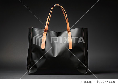 Black leather shopping bag close-up on a black background. Black Friday, discounts, sale. 109785666