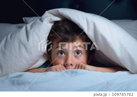 Young child is hiding under blanket on bed. This picture can be used to depict concepts of fear, hiding, comfort, or bedtime routines. Generative AI Young child is hiding under blanket on bed. This picture can be used to depict concepts of fear, hiding, comfort, or bedtime routines. Generative AI 109785702
