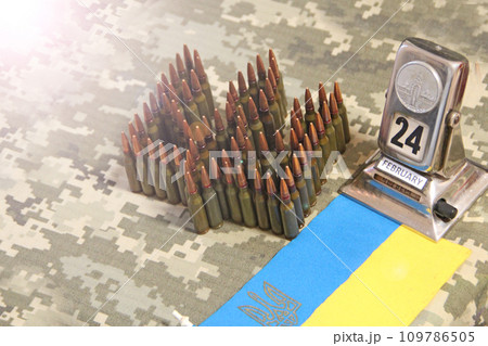 Cartridges for Kalashnikov assault rifle. War Concept. Ukrainian national symbol 109786505