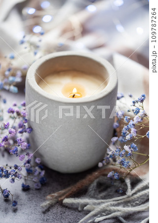 Candle and a branch of gypsophila flowers Candle and a branch of gypsophila flowers 109787264